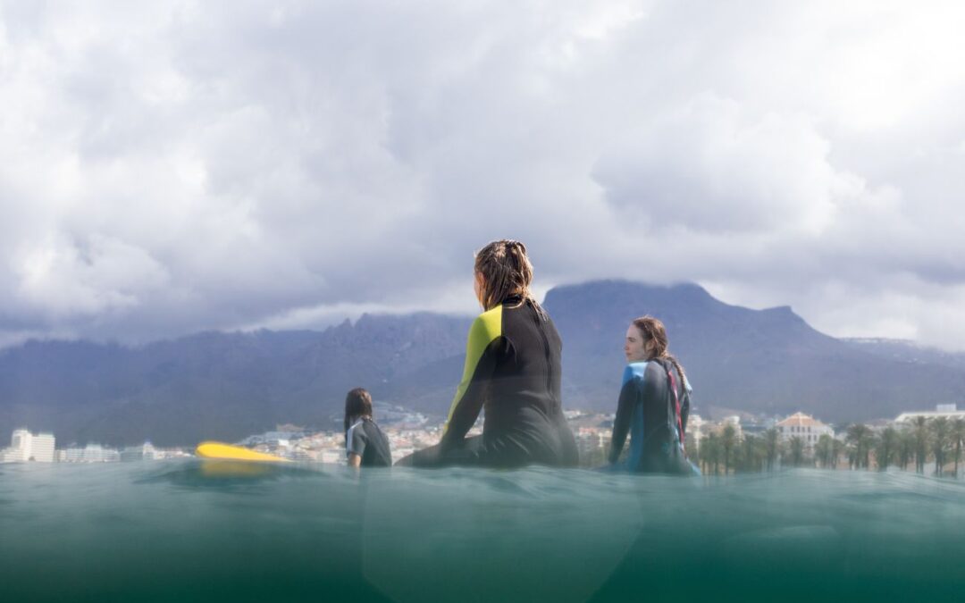 surfer girls on the surfing lesson in Playa de Las Americas, Tenerife